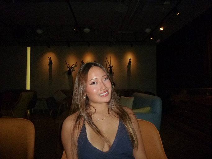 Zoey smiling at a restaurant
